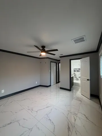 a bathroom with a granite countertop sink a toilet and shower