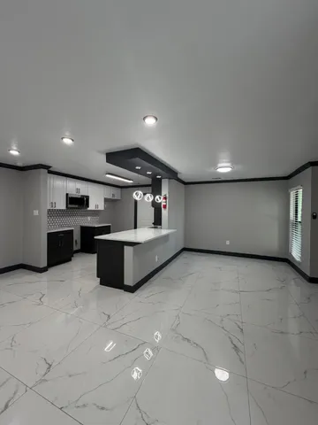 a kitchen with stainless steel appliances kitchen island granite countertop a stove a sink and a refrigerator