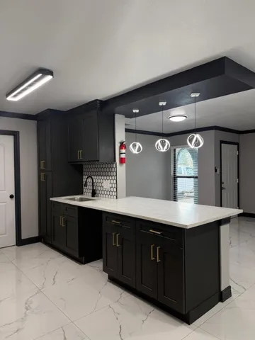 a kitchen with a sink and cabinets