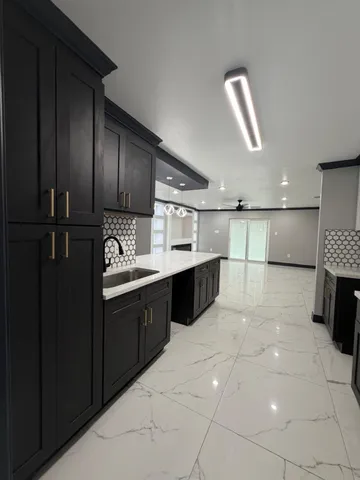 a kitchen with stainless steel appliances kitchen island granite countertop a sink and cabinets