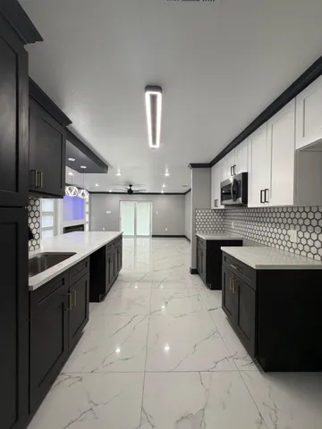 a view of kitchen with furniture and a refrigerator