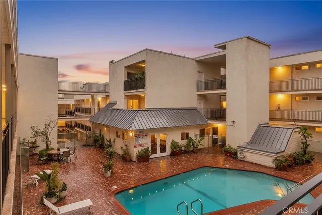 a balcony with furniture and a potted plant