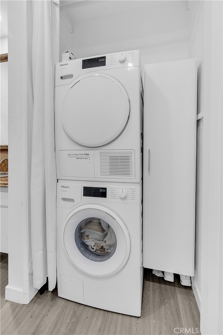 9005 Cynthia Street, Unit 317 West Hollywood, CA 90069 - Photo 13 of 23 a utility room with dryer and washer