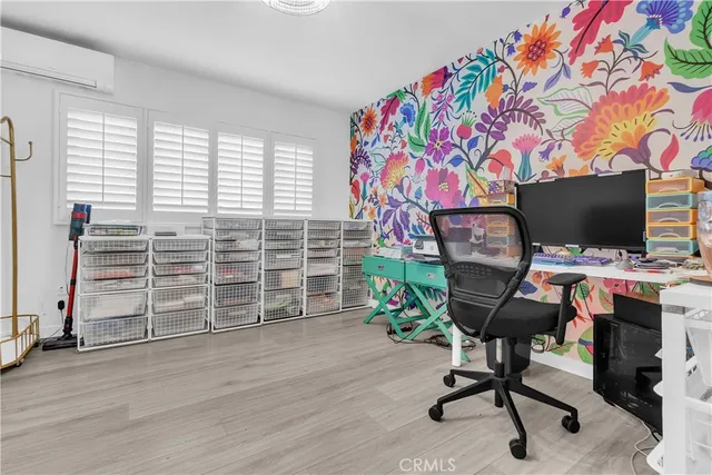 a view of a workspace with furniture and a window