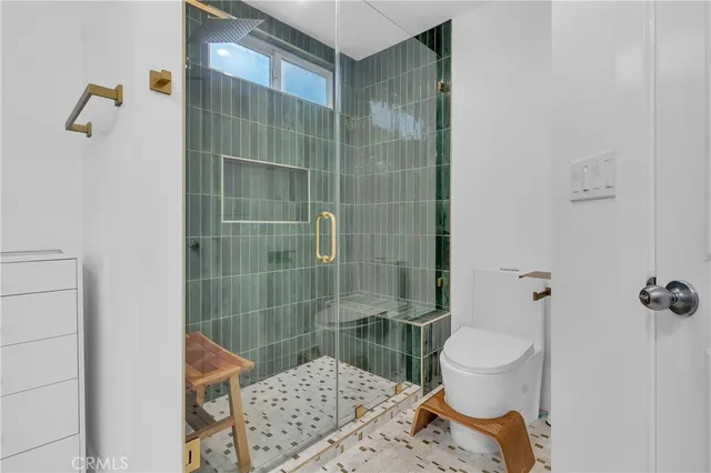 a bathroom with a toilet and shower