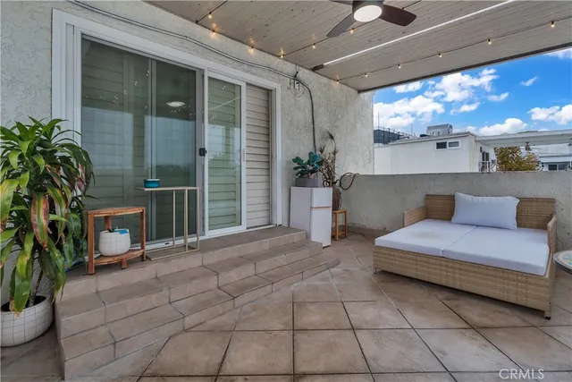 a spacious bedroom with a balcony a bed and a potted plant