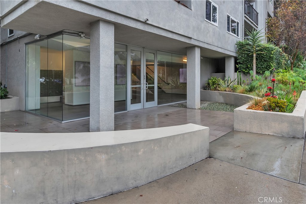 9005 Cynthia Street, Unit 317 West Hollywood, CA 90069 - Photo 23 of 23 front view of a house with potted plants and a potted plant