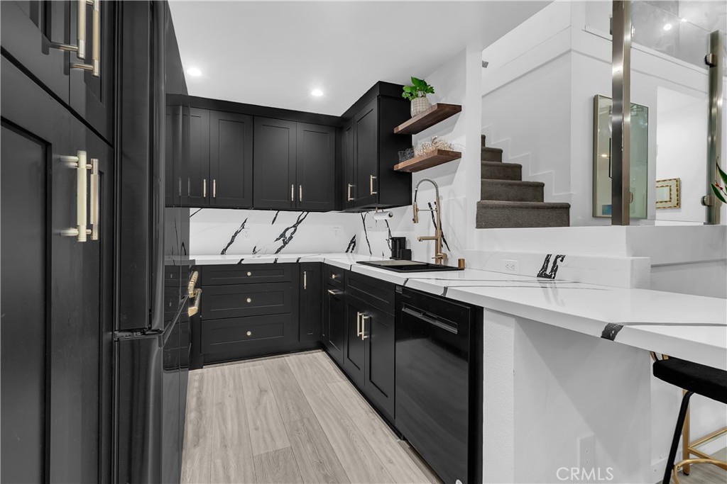 9005 Cynthia Street, Unit 317 West Hollywood, CA 90069 - Photo 3 of 23 a kitchen with a sink and cabinets