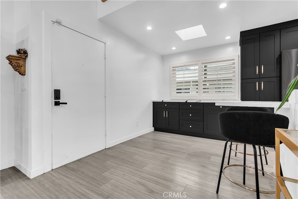 9005 Cynthia Street, Unit 317 West Hollywood, CA 90069 - Photo 6 of 23 a room with a wooden floor and a cabinet