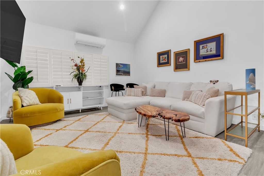 9005 Cynthia Street, Unit 317 West Hollywood, CA 90069 - Photo 9 of 23 a living room with furniture and a flat screen tv