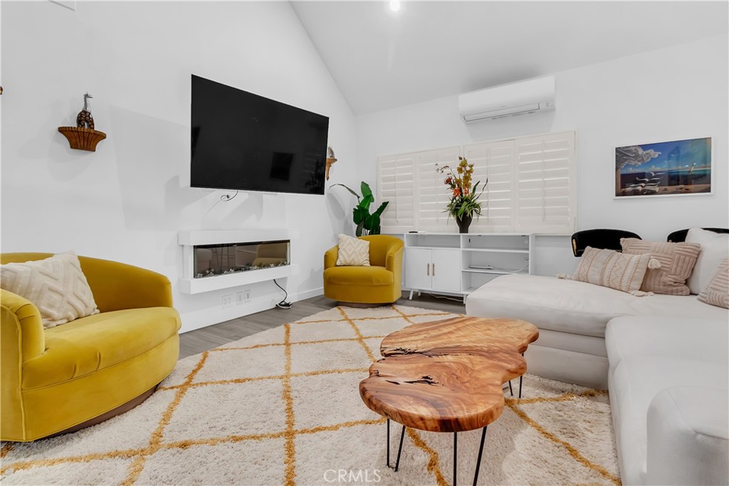9005 Cynthia Street, Unit 317 West Hollywood, CA 90069 - Photo 10 of 23 a living room with furniture and a flat screen tv