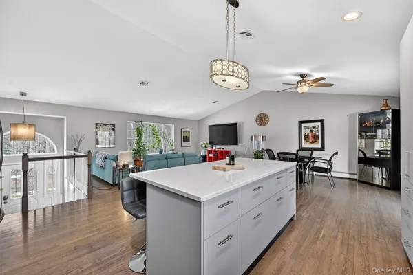 a view of a kitchen and a dining table chairs