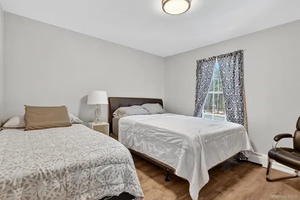 a bedroom with two beds and a window