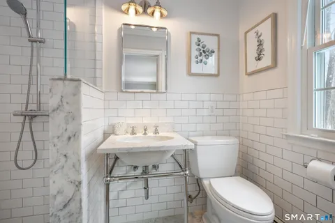a bathroom with a toilet sink and shower