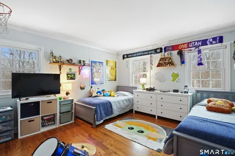 a bedroom with furniture and a flat screen tv