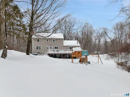 a view of a house with snow on the road