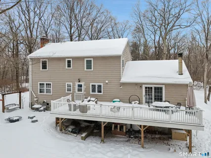 a backyard of a house with table and chairs