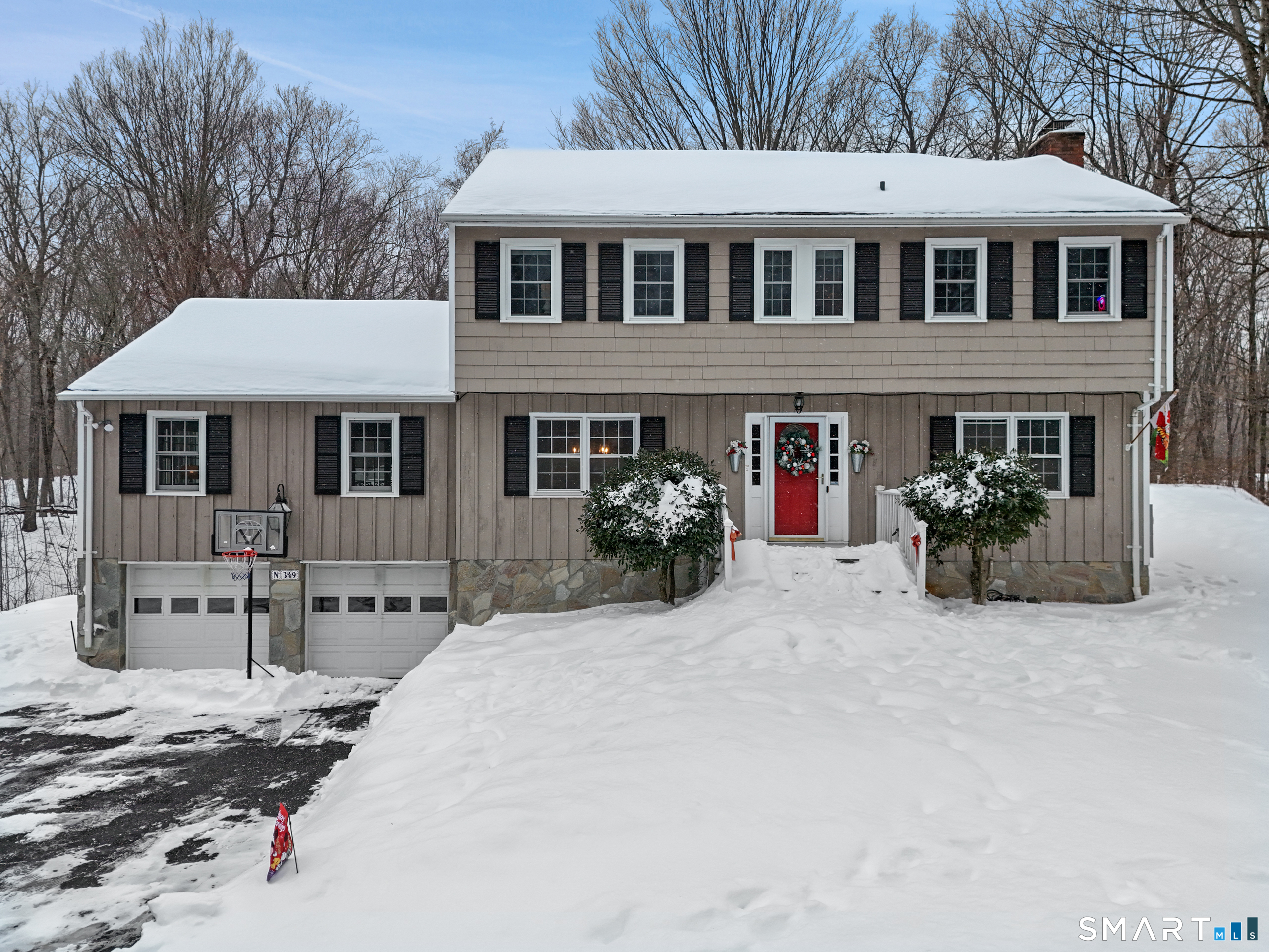 349 Mountain Road Wilton, CT 06897 - Photo 24 of 33 a view of a white house with large windows and a small yard