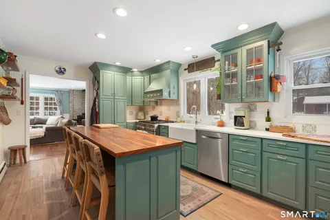 a kitchen with stainless steel appliances granite countertop a sink and cabinets