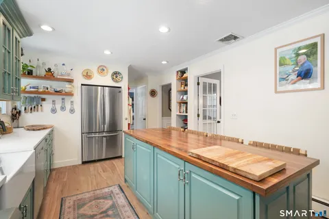 a kitchen with refrigerator and cabinets
