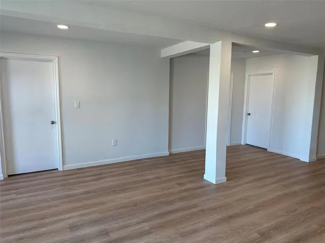 a view of wooden floor and windows in an empty room