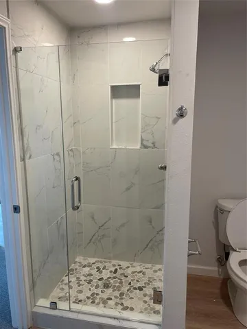 a bathroom with a toilet sink and shower