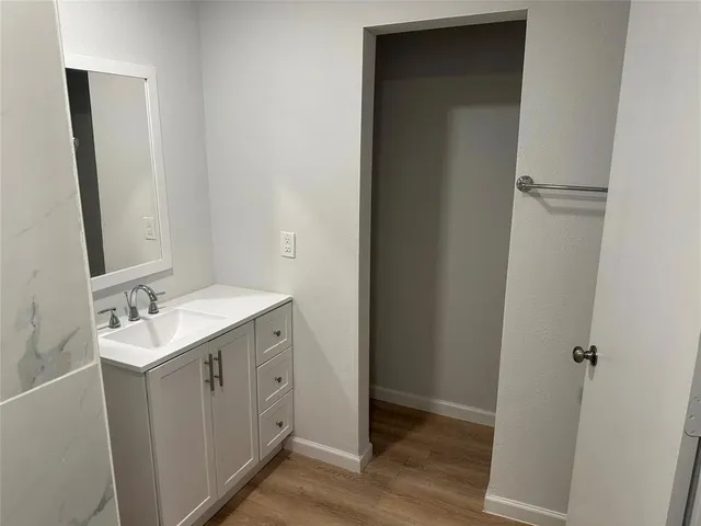 a view of a bathroom with a sink and mirror