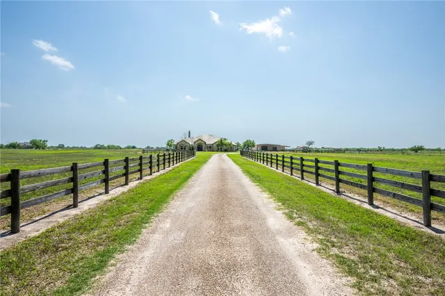 a view of a house with swimming pool and a yard