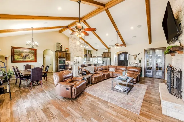 a living room with furniture a flat screen tv and a table