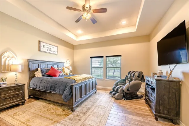 a room with a bed window and a flat screen television