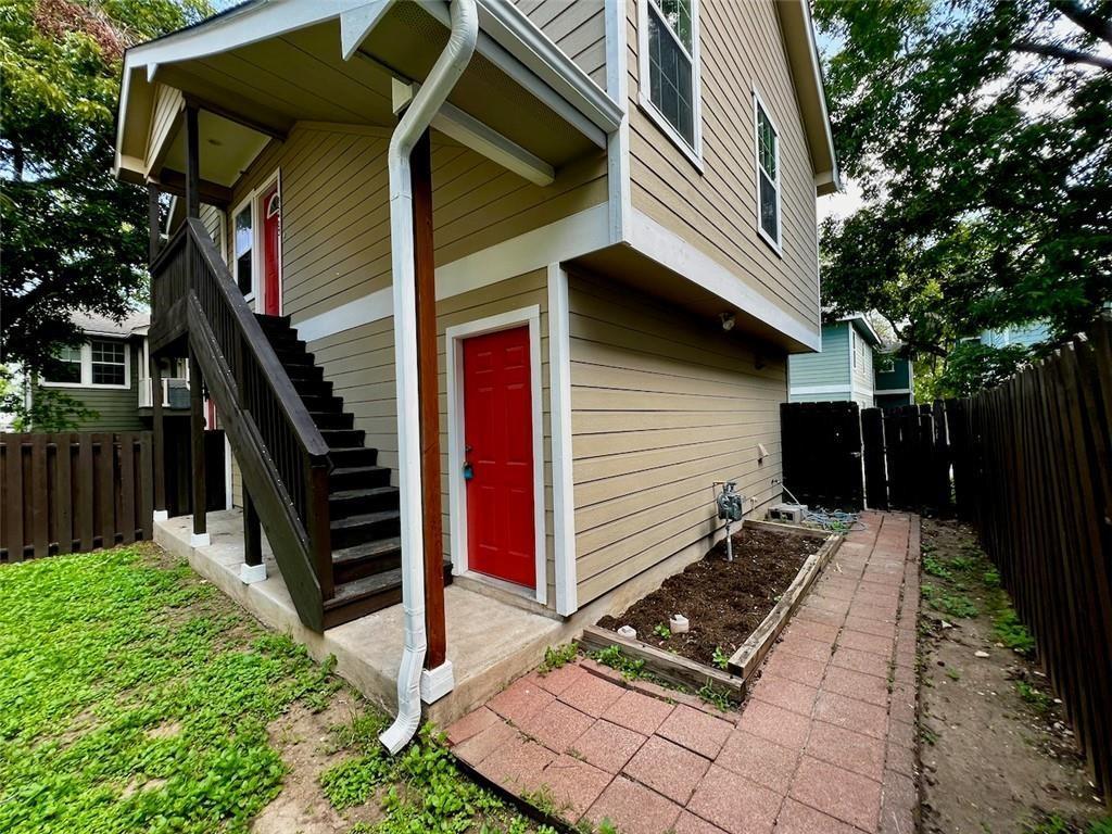 a view of a house with backyard and trees