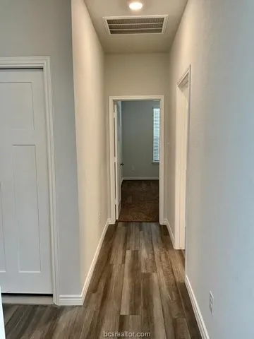 a view of a hallway view with wooden floor and staircase