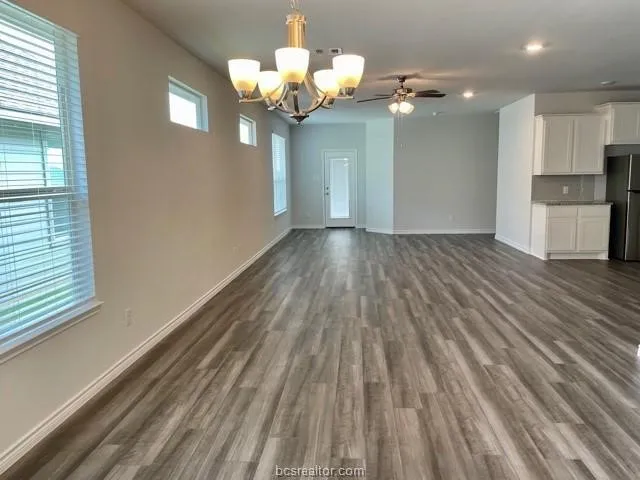 a view of a room with wooden floor