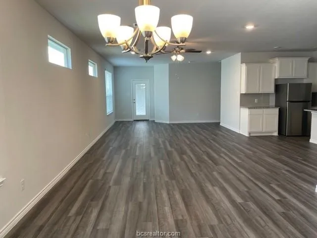 a view of a room with wooden floor