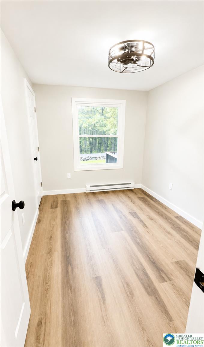 182 Mountain Road Albrightsville, PA 18210 - Photo 10 of 17 A tranquil sanctuary, this room offers warm wood-look flooring and a window overlooking lush greenery.