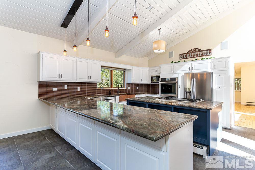 1755 Berkeley Drive Reno, NV 89509 - Photo 9 of 33 a large kitchen with kitchen island granite countertop a sink and stainless steel appliances