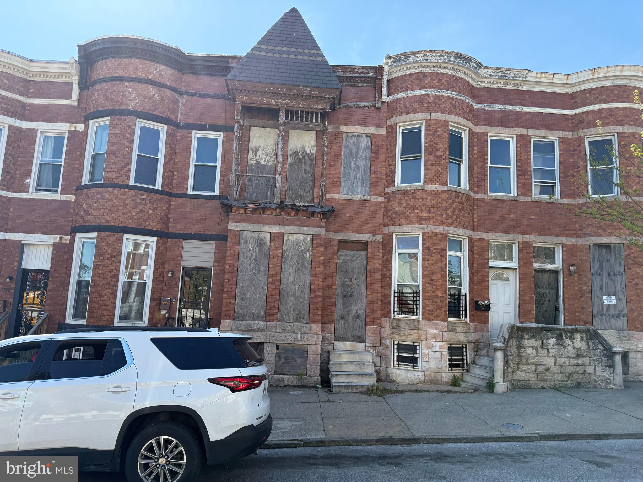1306 North Luzerne Avenue Baltimore, MD 21213 - Photo 1 of 3 a front view of a building with parking space