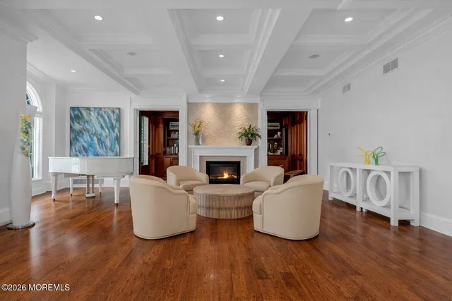 a living room with furniture ceiling fan and a large window