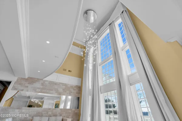 a living room with furniture and a chandelier