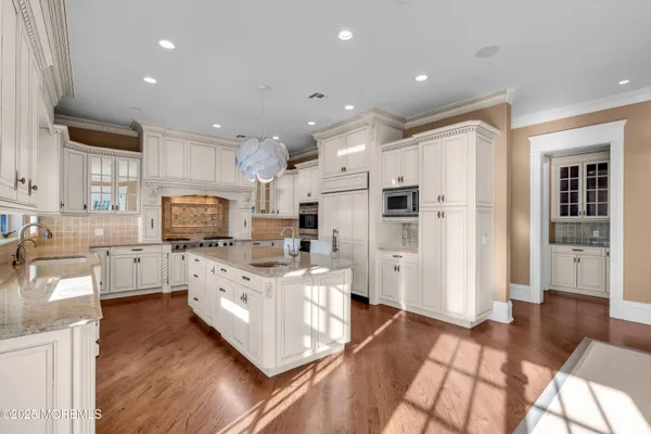 a kitchen with stainless steel appliances a refrigerator sink and cabinets