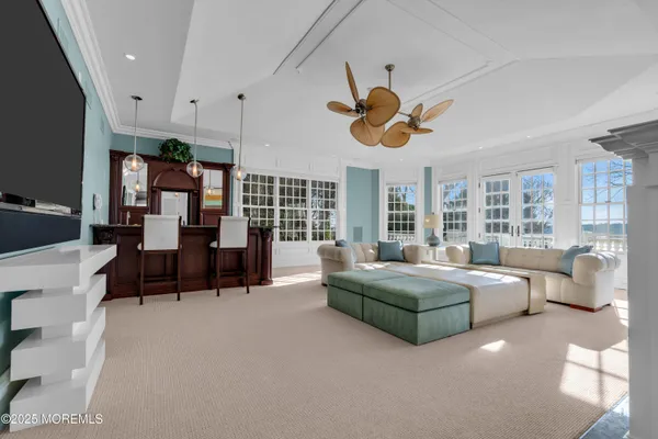 a living room with furniture and large windows