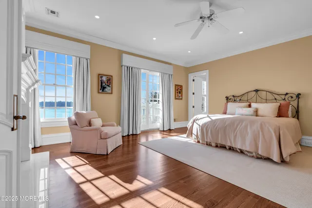 a spacious bedroom with a bed and flat screen tv