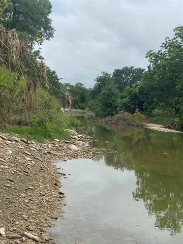 a view of a lake view with houses in back