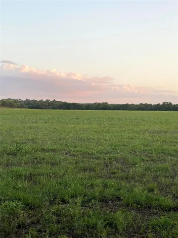 a view of a lake with a yard