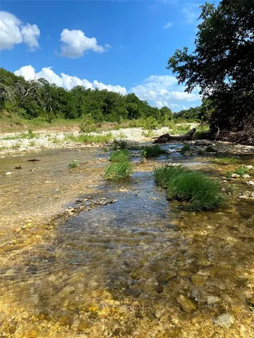 a view of lake with green space
