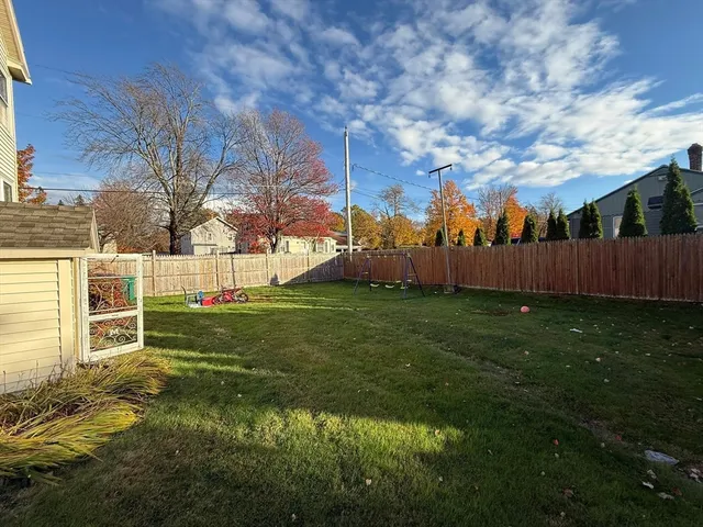 a view of backyard with table and chairs