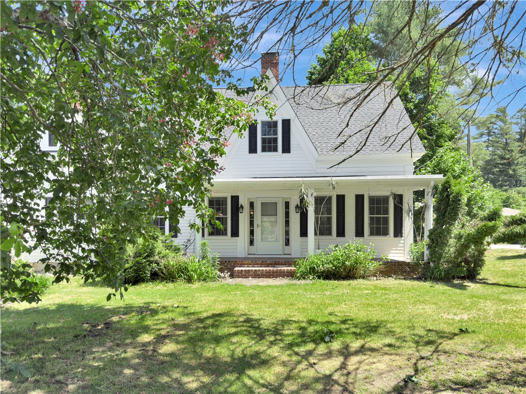 33 Indian Pond Road Kingston, MA 02364 - Photo 1 of 44 Pink Chestnut tree in bloom framing front facade