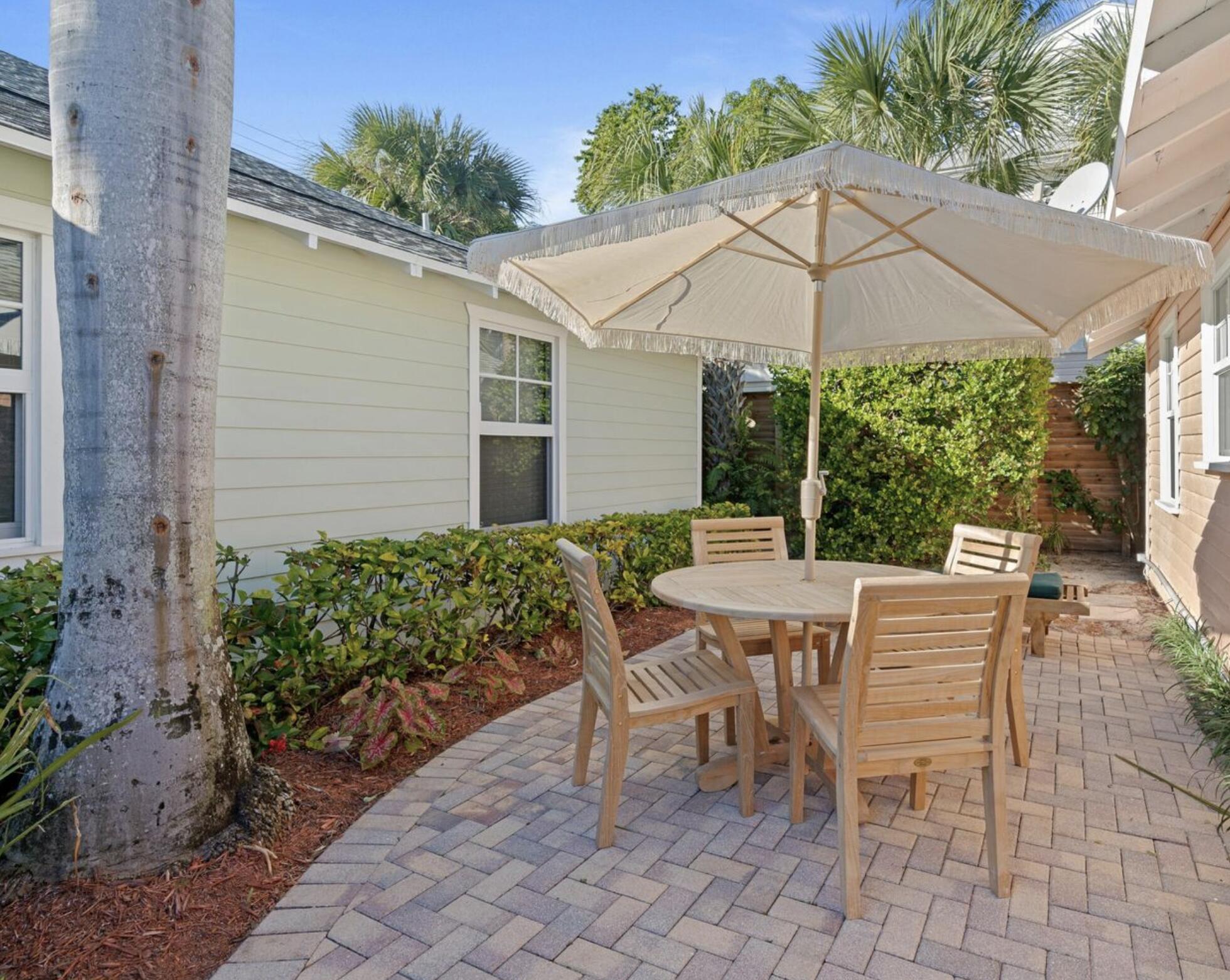 118 Southeast 7th Avenue Delray Beach, FL 33483 - Photo 11 of 17 a view of a patio with a table and chairs under an umbrella