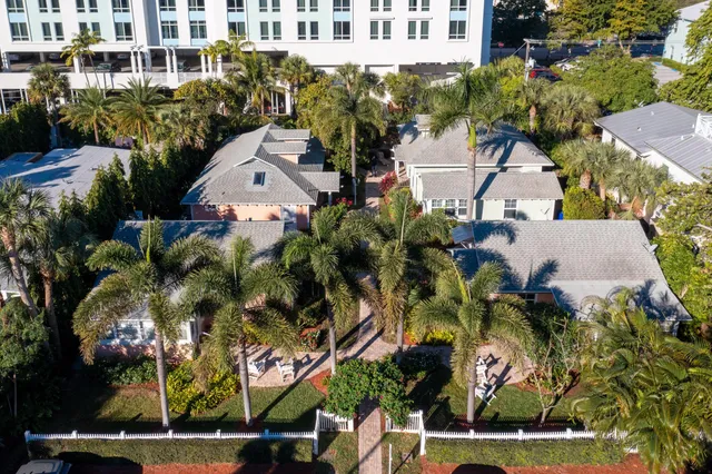 an aerial view of a house with a yard and large trees