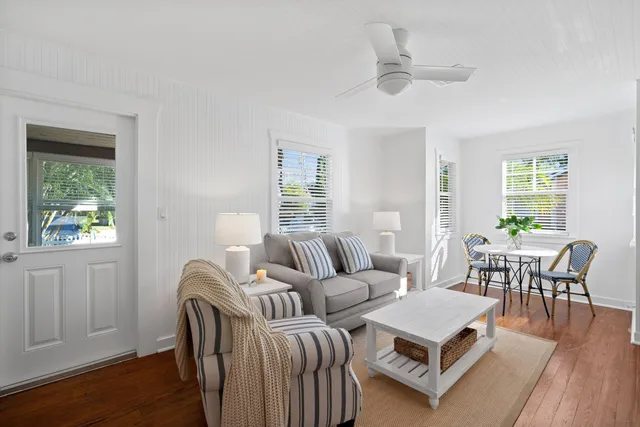 a living room with furniture a window and a table